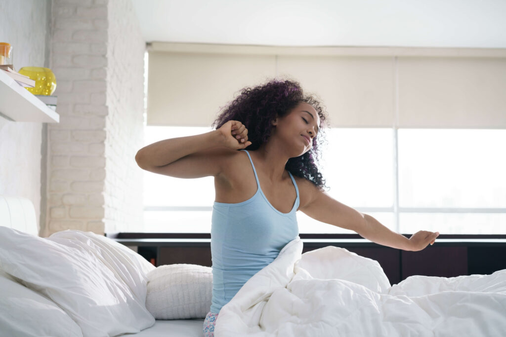 Beautiful Young African American Woman Waking Up In Bed, Matthews, NC